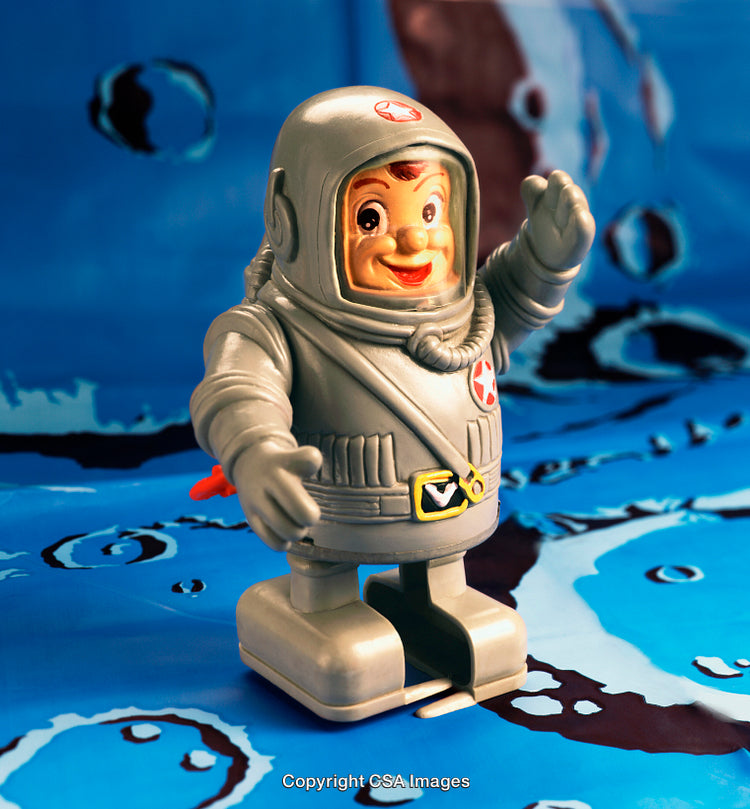 Vintage Plastic Astronaut Toy on a Retro Blue Background