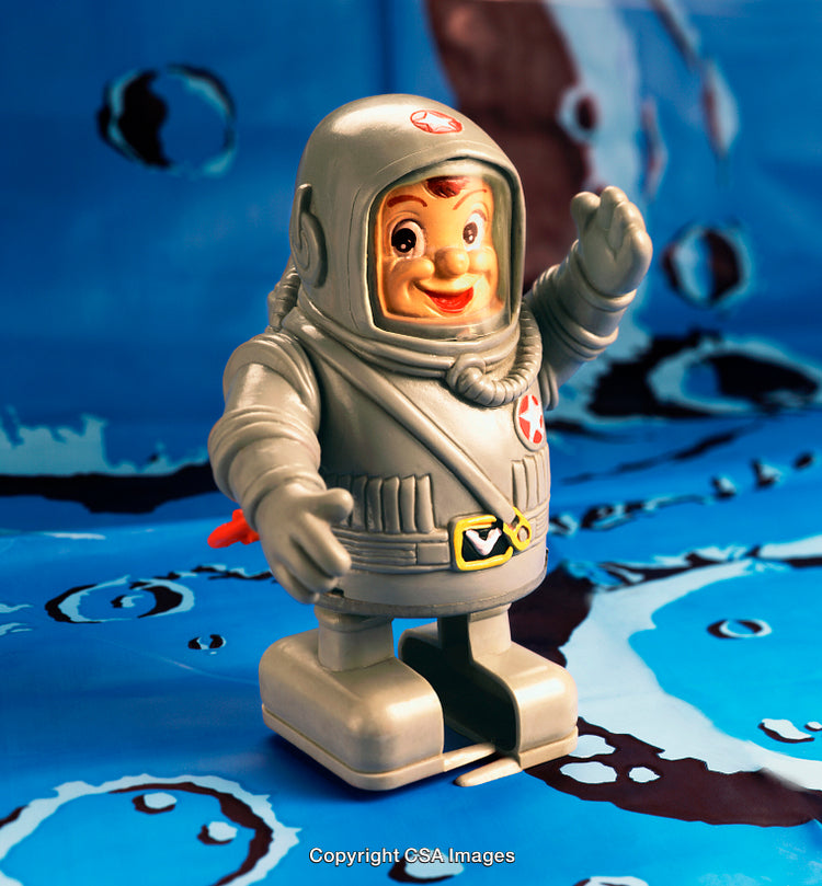 Vintage Plastic Astronaut Toy on a Retro Blue Background