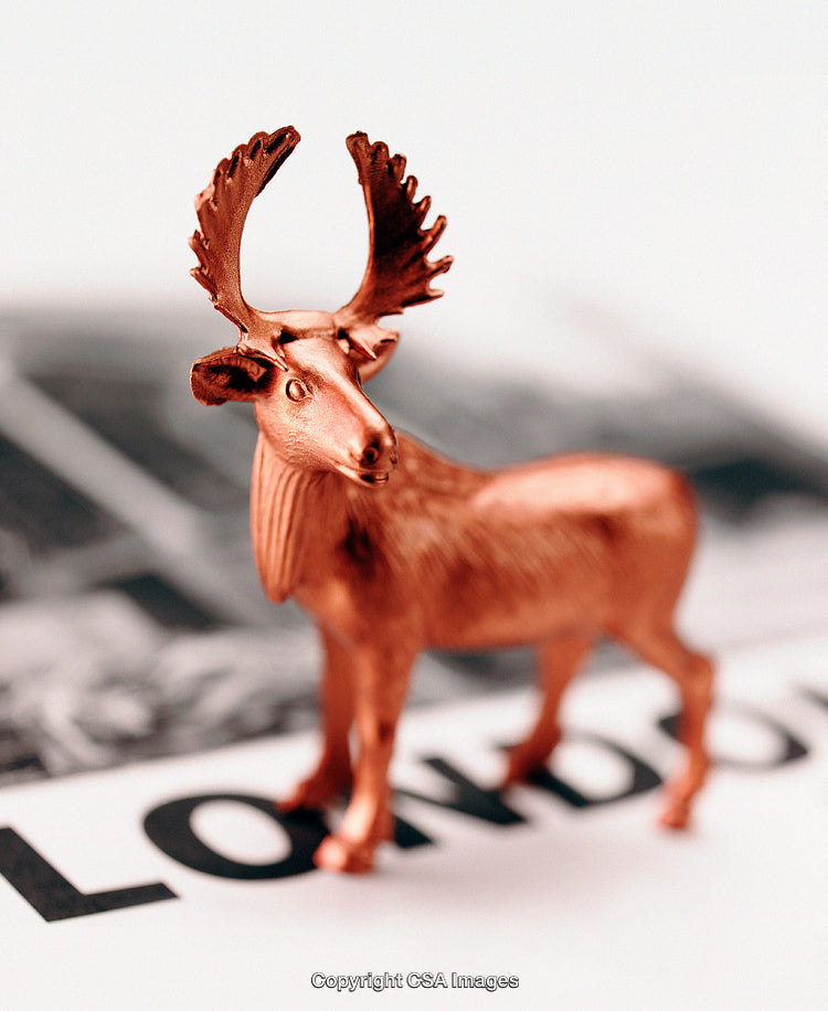 Copper Tone Moose Figurine on Abstract London Text Illustration