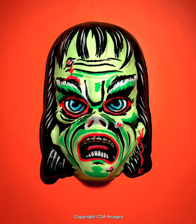 Colorful Vintage Monster Mask with Eye-Catching Details on Orange Background
