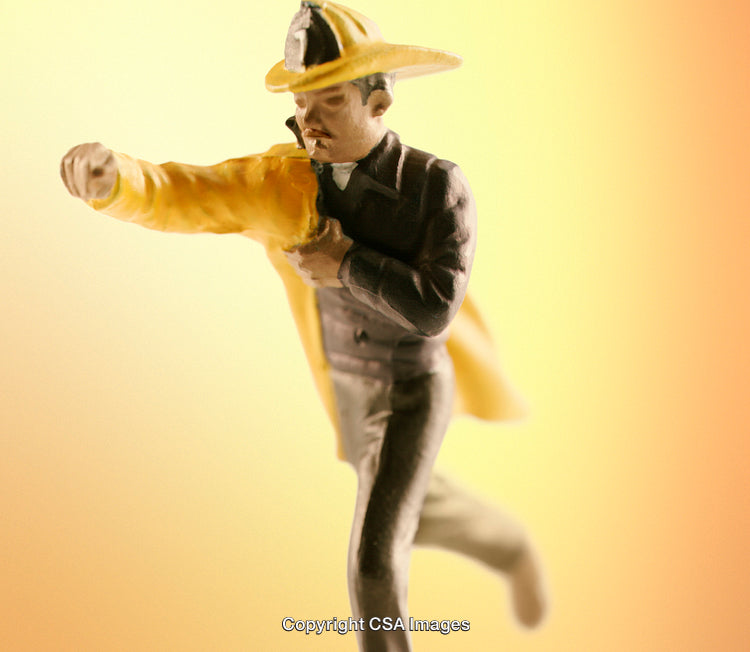 Close-Up of Firefighter Figurine on a Gradient Background