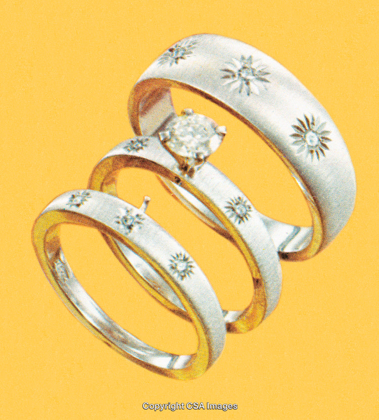 Elegant Silver Rings With Diamond and Intricate Engravings on Yellow Background