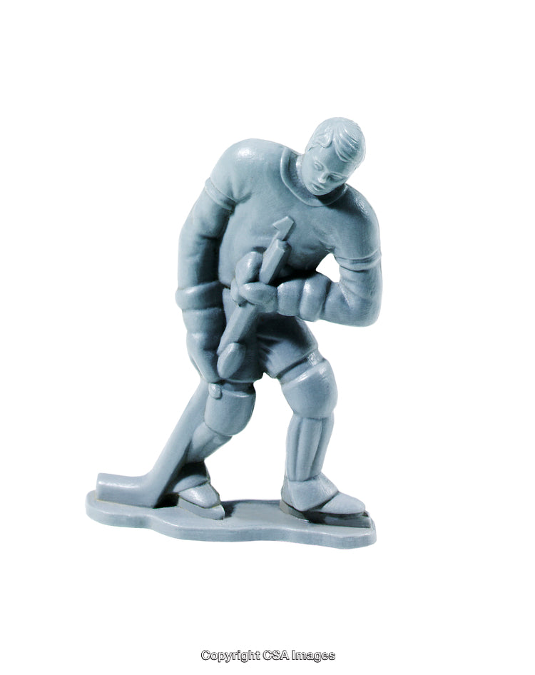 Gray Plastic Toy of a Hockey Player Holding a Stick on White Background