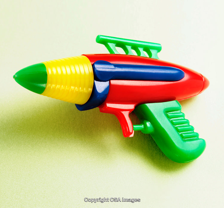 Colorful Plastic Toy Water Gun Isolated on a Light Green Background