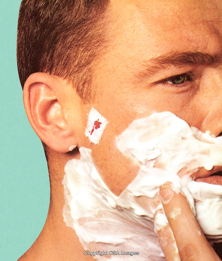 Close-Up of Shaving Routine with Lathered Face and Small Bandage