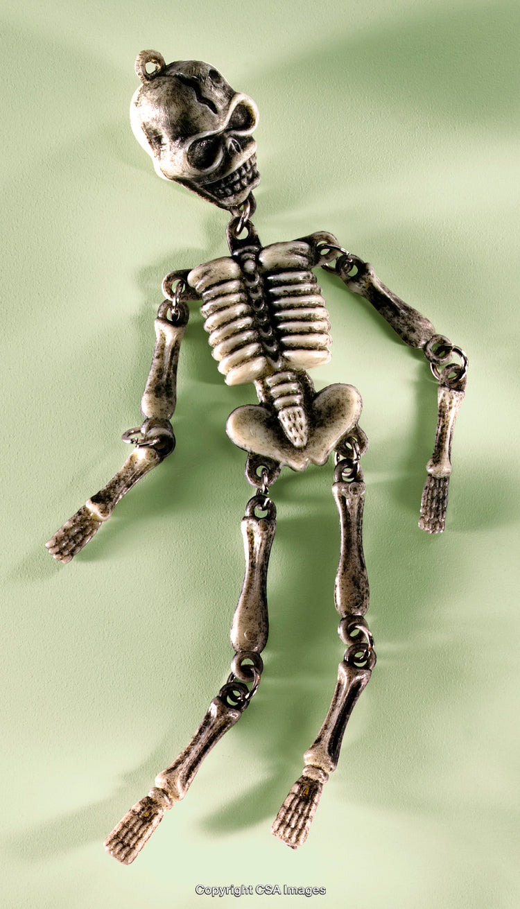 Toy Skeleton Pendant with Intricate Detail on a Light Green Background