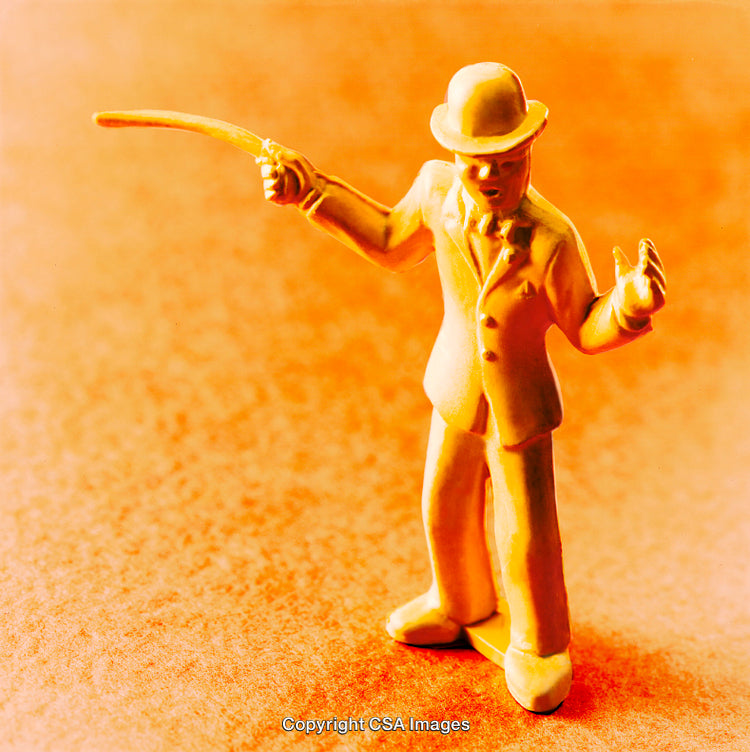 Close-Up of an Orange Plastic Toy Figure on a Textured Surface
