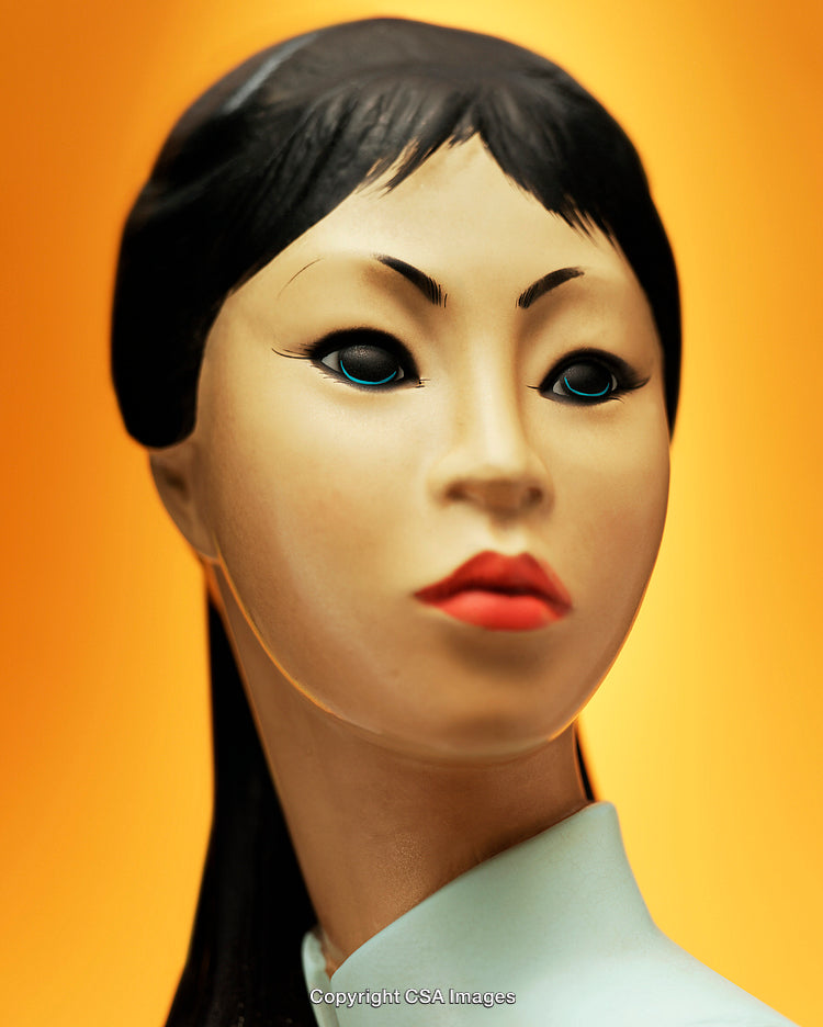 Close-Up of Stylized Plastic Figure Against Bright Orange Background