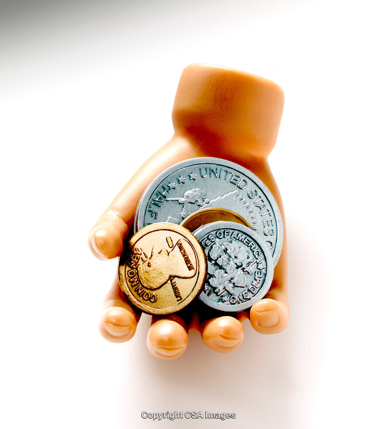 Plastic Toy Hand Holding Coins Representing Financial Savings and Wealth