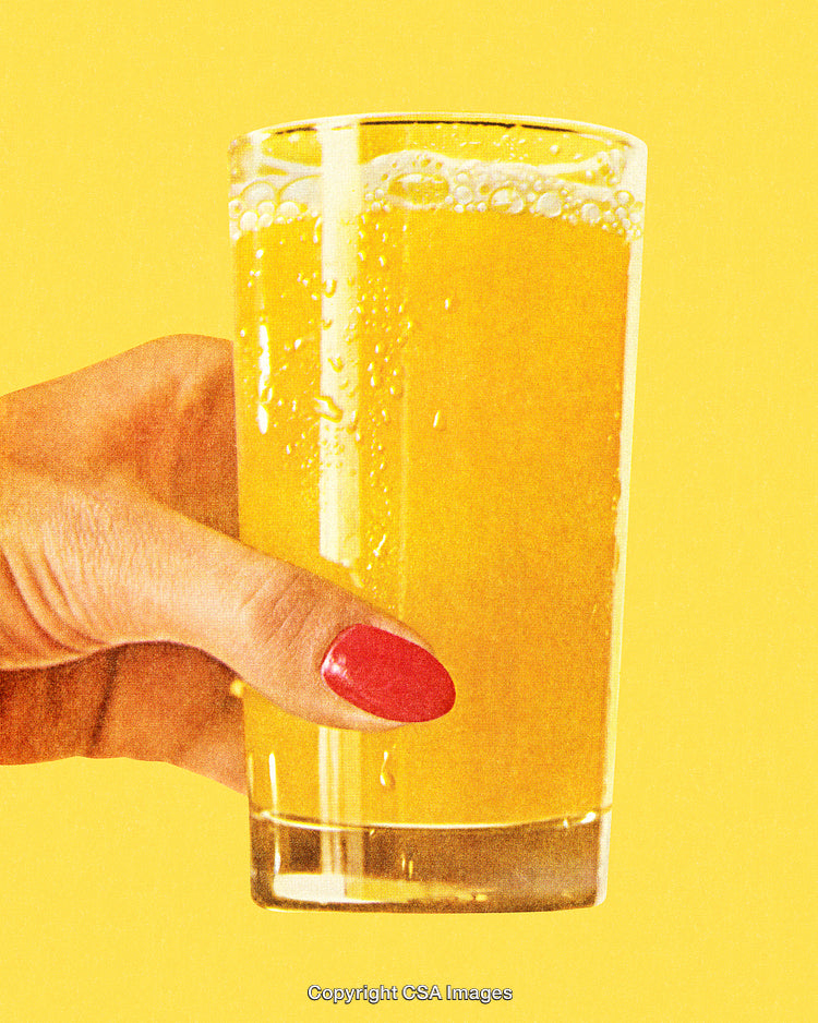 Hand Holding a Glass of Refreshing Yellow Orange Juice on Yellow Background