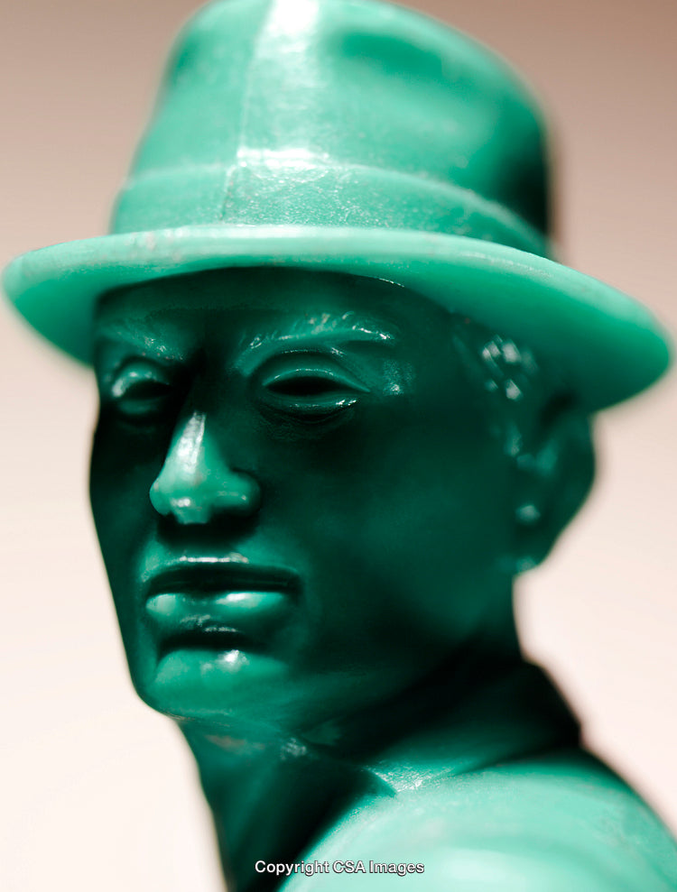 Close-Up of Green Plastic Figurine Wearing a Stylish Hat