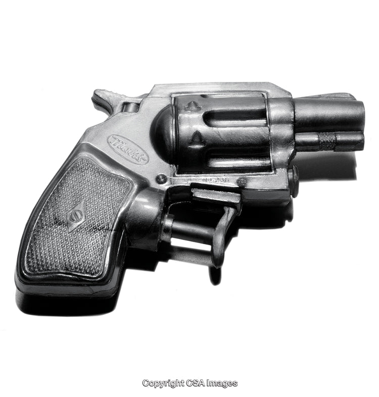Close-Up of a Vintage Plastic Toy Revolver Under Dramatic Lighting