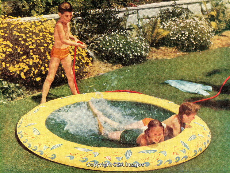 Children Playing Outdoors in an Inflatable Pool on a Sunny Day