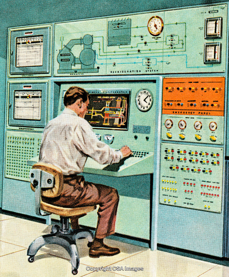 Technician Monitors Control Room Panel with Screens and Switches