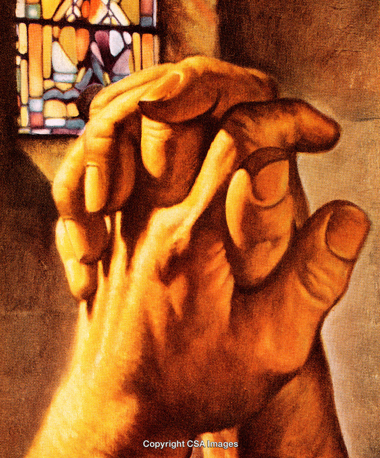 Praying Hands Near a Colorful Stained Glass Setup in Warm Lighting