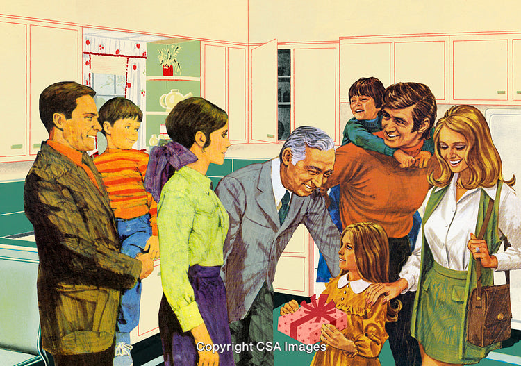Cheerful Multigenerational Family Gathered in Kitchen Sharing a Gift