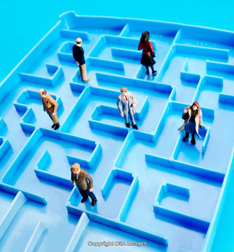 Miniature Figures Exploring a Maze Symbolizing Challenges and Decisions