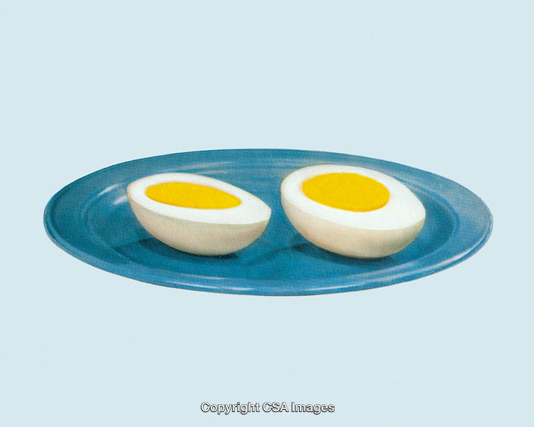 Halved Boiled Eggs Displayed on a Minimalistic Blue Plate