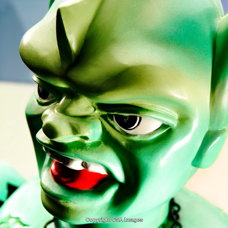 Close-Up of a Green Plastic Figurine With Expressive Features