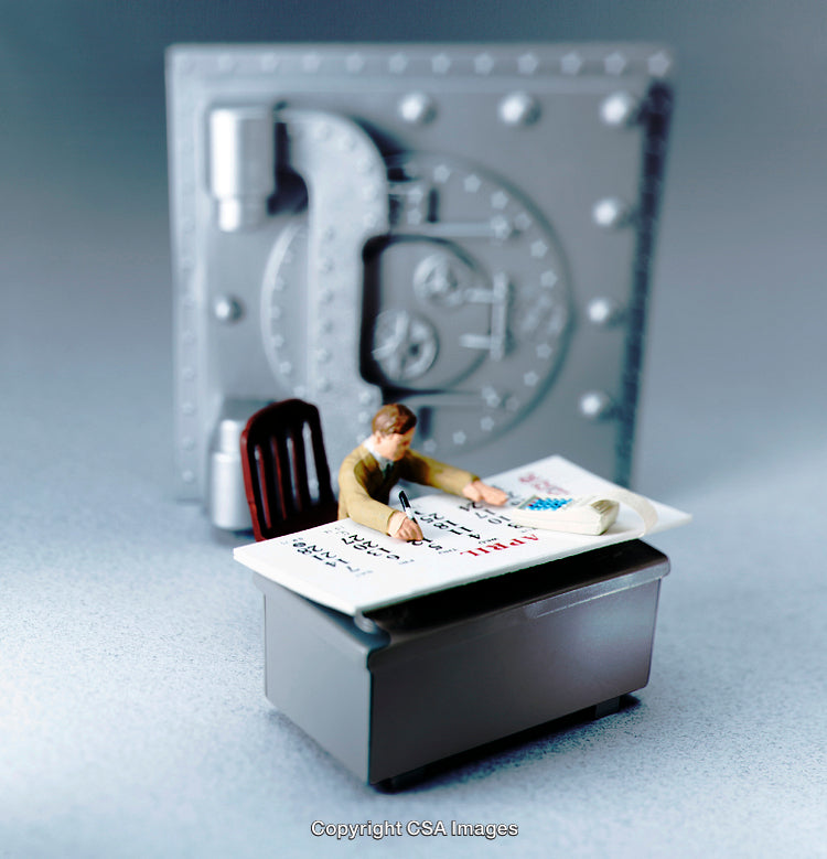 Miniature Figure Planning on Desk with Vault in Background
