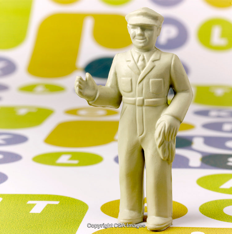 Plastic Toy Figure on Colorful Background with Letters and Symbols