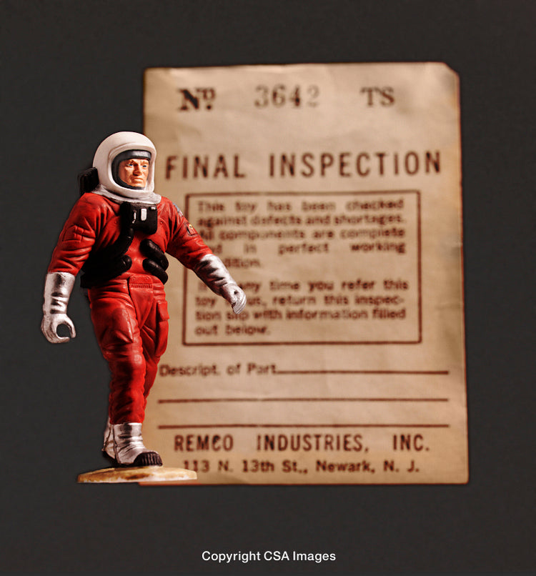 Vintage Toy Astronaut with Inspection Label on Annotated Note