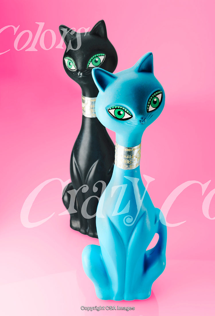 Vibrant Black and Blue Cat Figurines Against a Bright Pink Background
