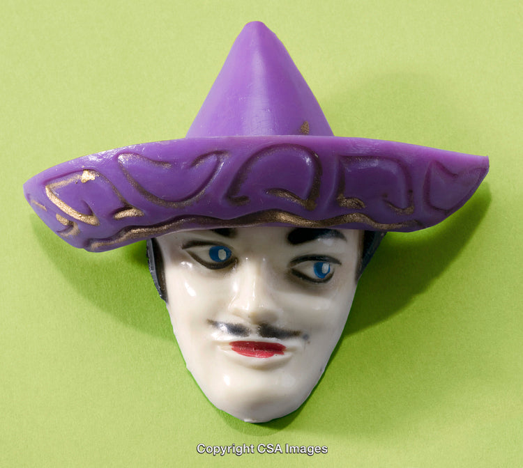 Purple-Accented Vintage Toy Mask Against Green Background Display