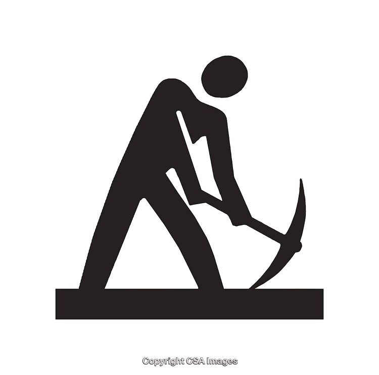 Silhouetted Worker Using a Pickaxe for Digging or Construction Tasks