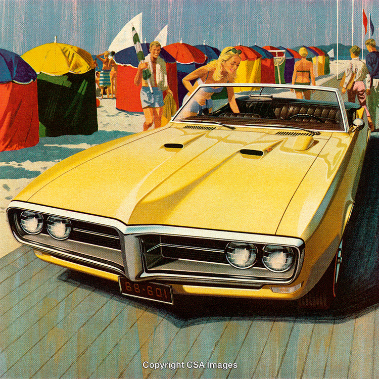 Vintage Yellow Convertible on Beach with Colorful Umbrellas and People