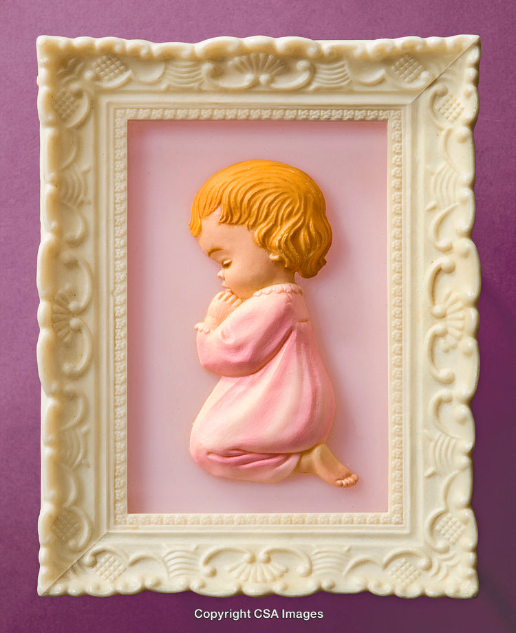 Decorative Framed Child Figure in Prayer Against a Purple Background