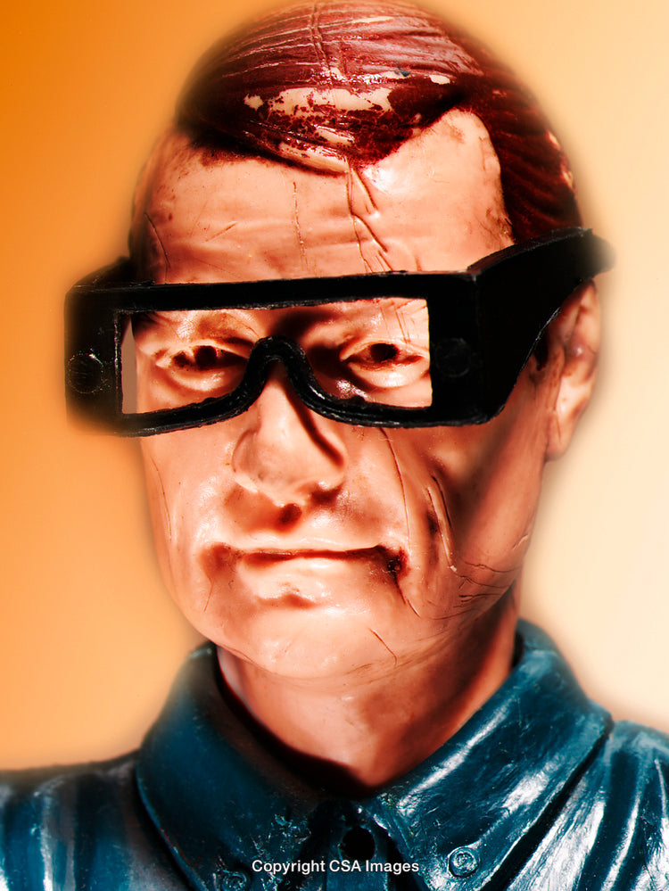 Detailed Close-Up of a Vintage Plastic Figurine with Glasses