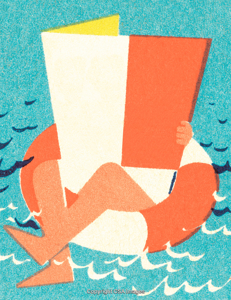 Person Relaxing On a Float While Reading a Book in the Ocean