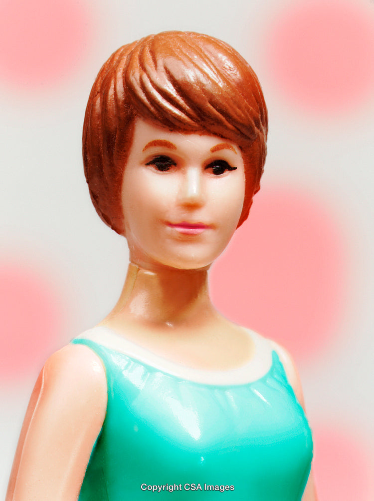 Portrait of a Plastic Figurine with Red Hair in Aqua Dress