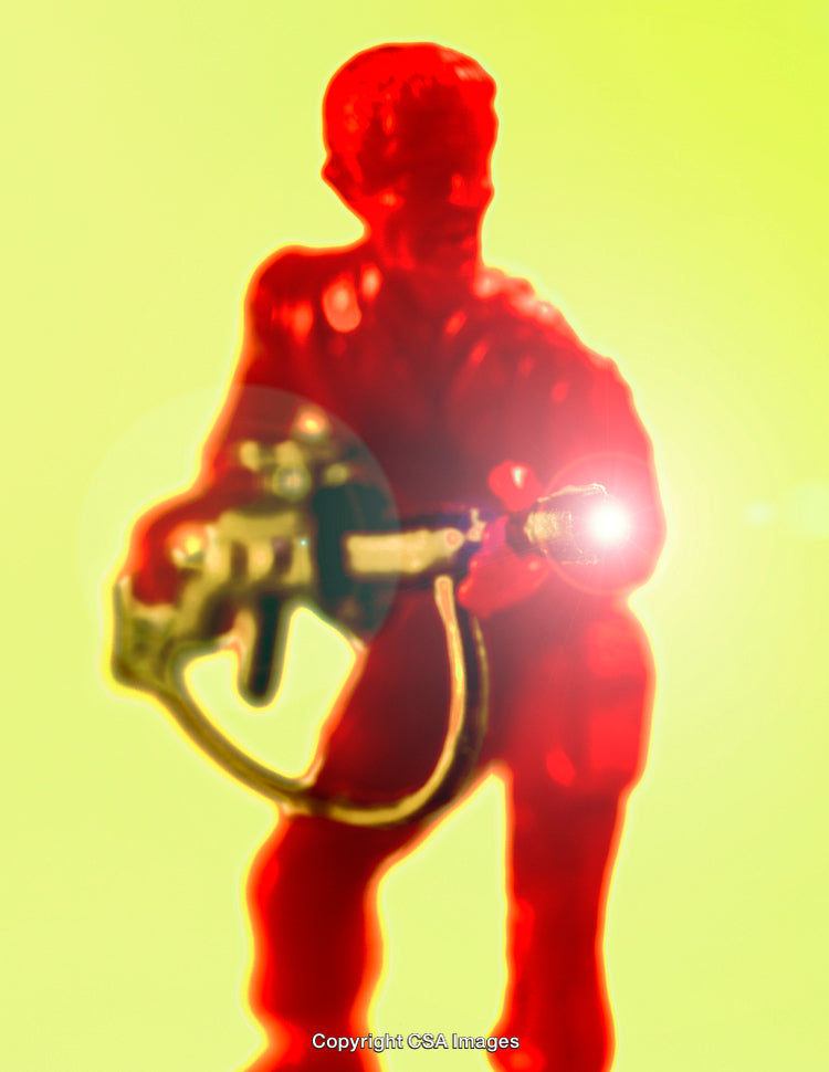 Close-Up of Red Toy Soldier With Light Effect on Yellow Background
