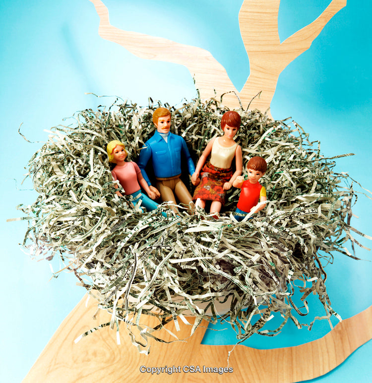 Family Figurines Resting in a Nest Made of Shredded Paper