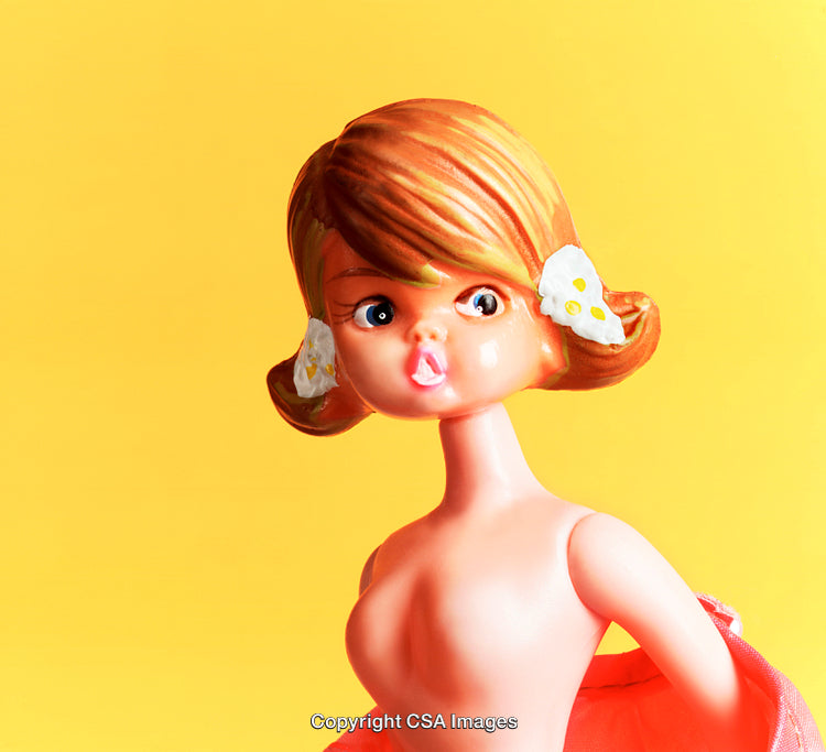 Retro Styled Plastic Figurine Against Bright Yellow Background