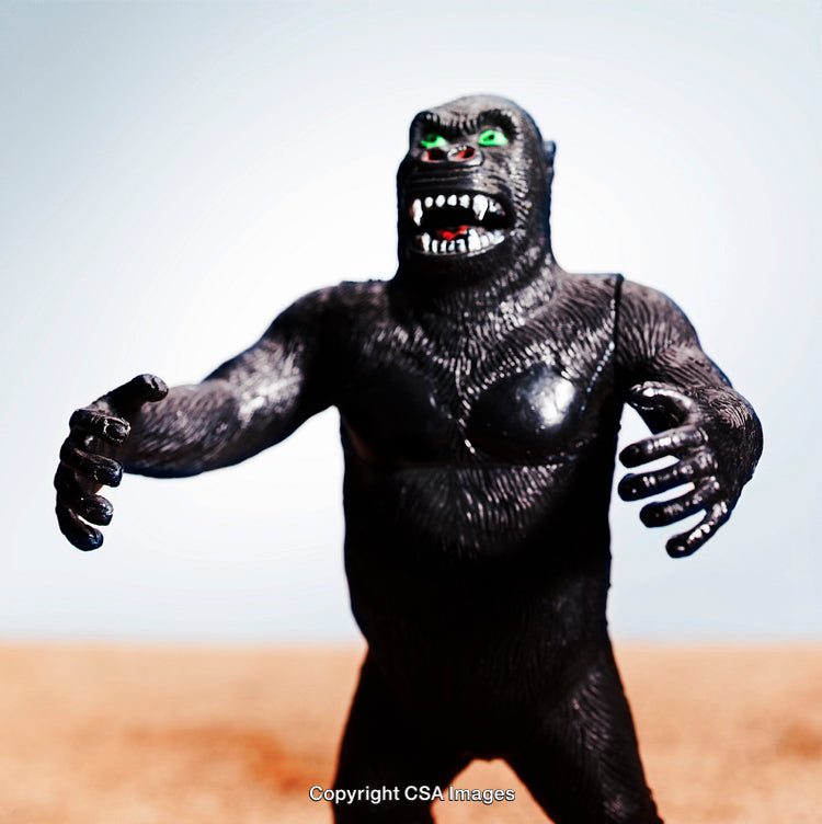 Detailed Close-Up of a Black Gorilla Action Figure Outdoors