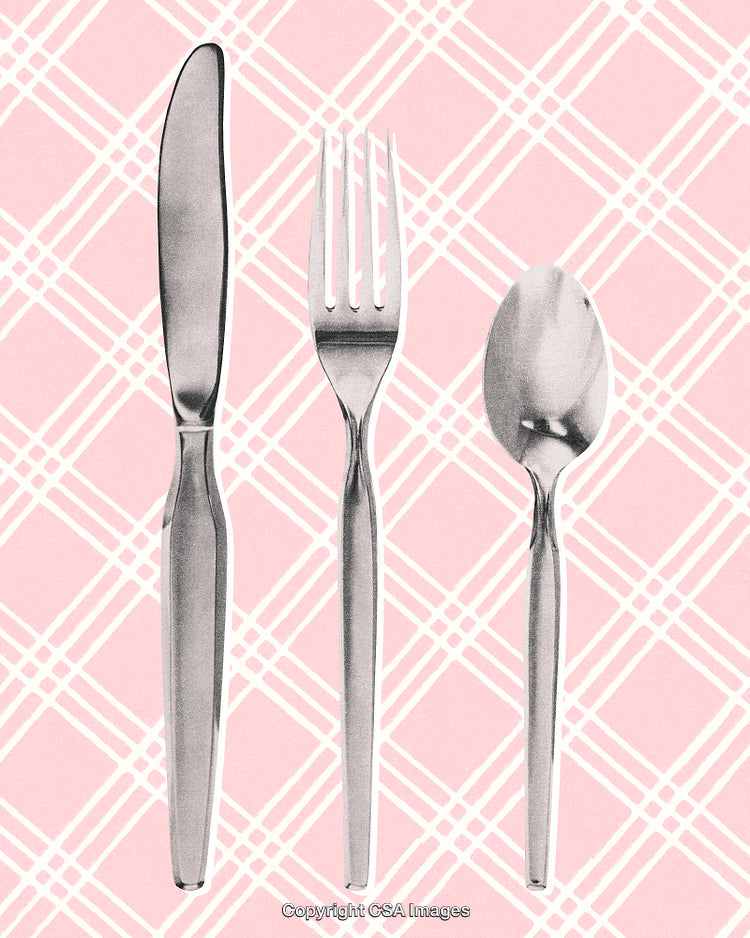 Silver Cutlery Set Displayed Against a Pink Patterned Background