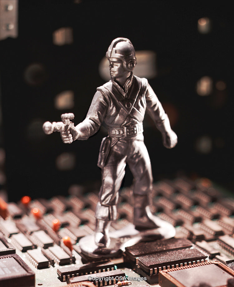 Plastic Soldier Toy Standing on Electronic Circuit Board with Dark Background