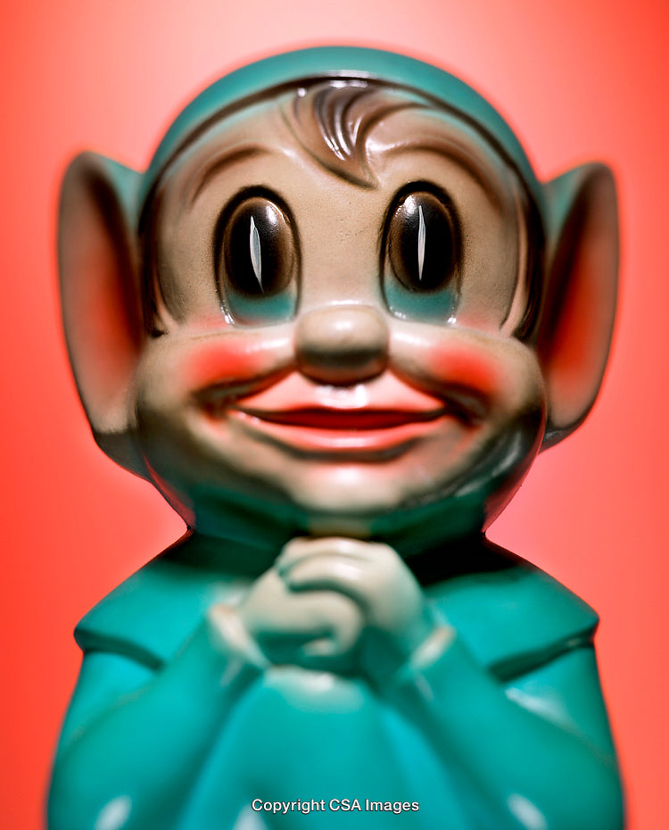 Colorful Plastic Figure with Whimsical Expression on Vibrant Background