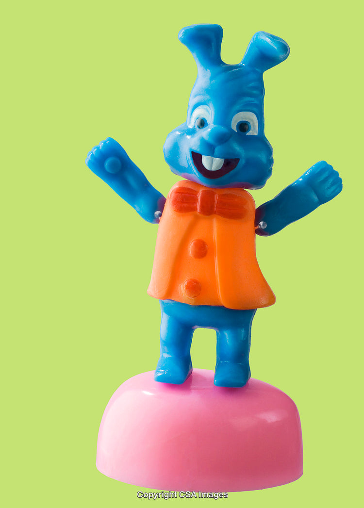 Blue Rabbit Figurine With Orange Bow Tie on Green Background