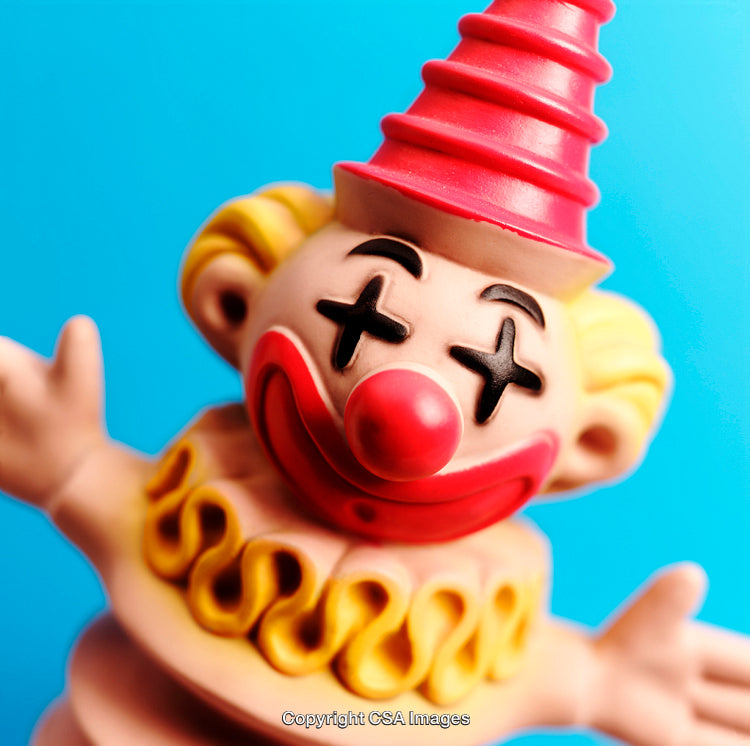 Playful Toy Clown Figure on Bright Blue Background