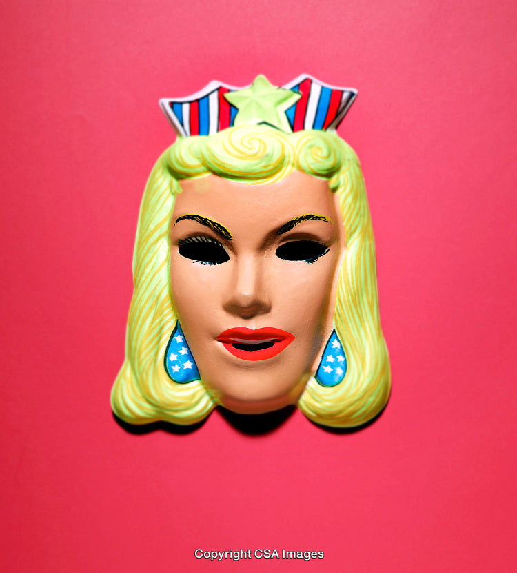 Colorful Vintage Plastic Mask Against a Bright Pink Background