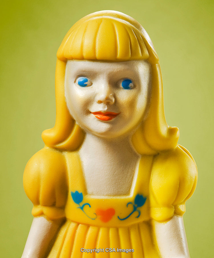 Close-Up of Vintage Yellow Plastic Doll Toy Figurine