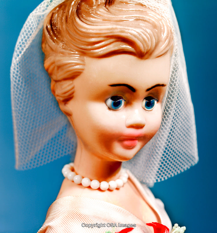 Close-Up of Vintage Bride Doll with Veil and White Pearl Necklace
