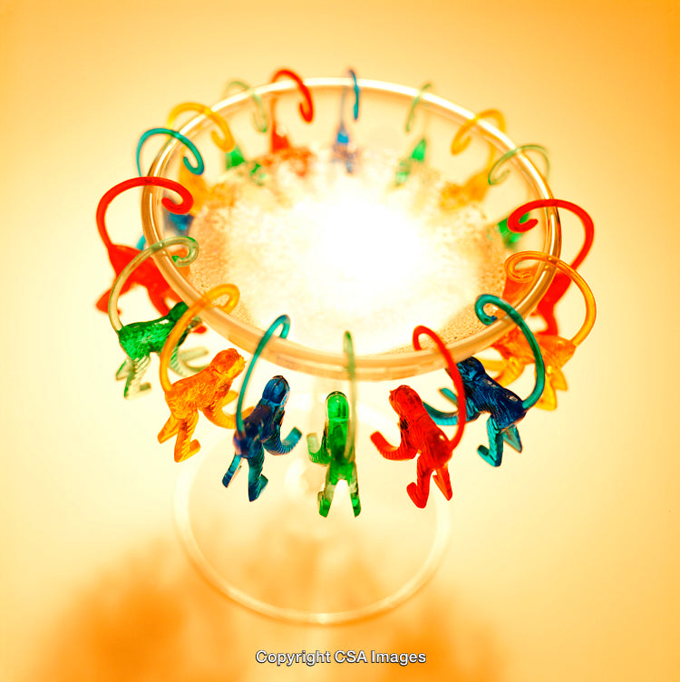 Colorful Plastic Monkey Toys Surrounding a Vibrant Circular Arrangement