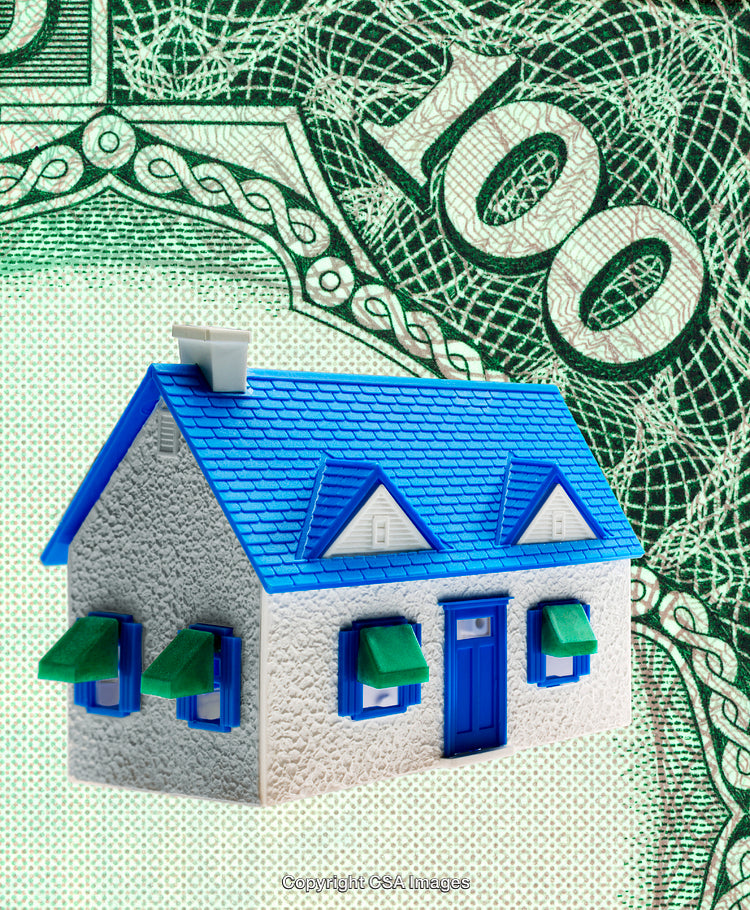 Miniature House Concept with Money Background for Financial and Real Estate Themes