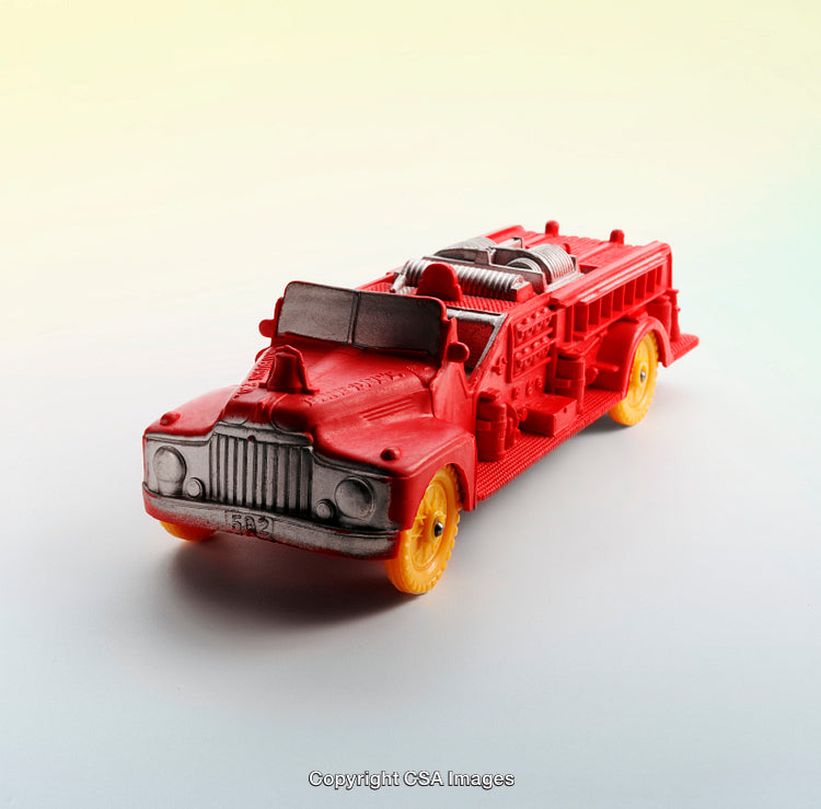 Red and Yellow Plastic Toy Fire Truck on Gradient Background