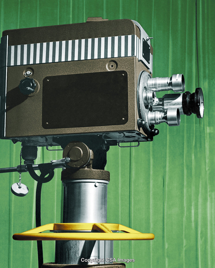 Retro Cinema Camera on Tripod Against a Vibrant Green Background